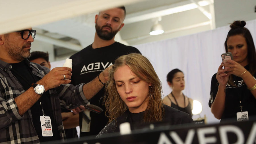 Model getting hair done at fashion show