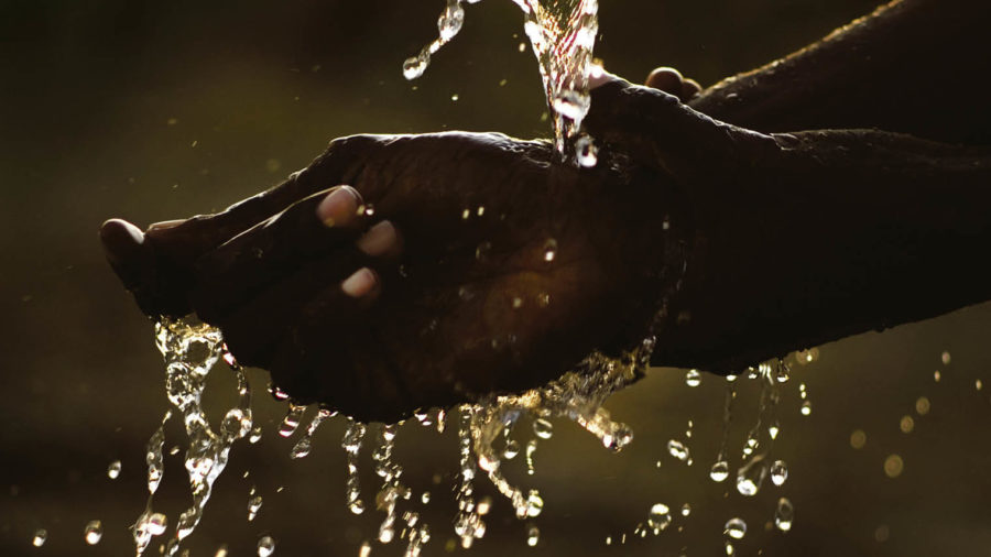 Hands being washed in water