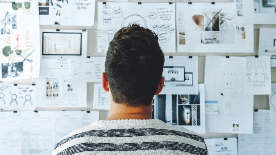 Professional looking at brainstorming pinboard