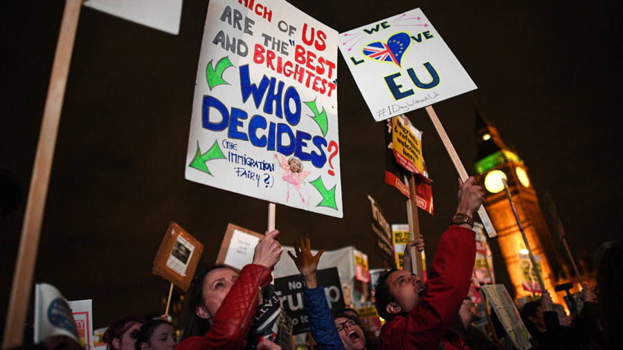 Protesters holding placards gather near the Houses of Parliament as protesters against Brexit join an anti-Trump protest in London on February 20, 2017, as parliament debates whether or not to allow Donald Trump a state visit.