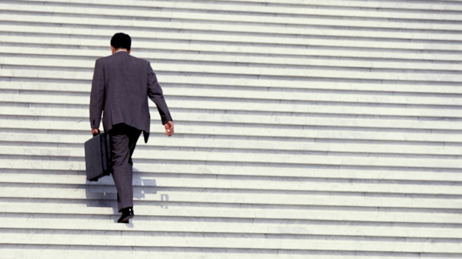 Man in suit walking up stairs
