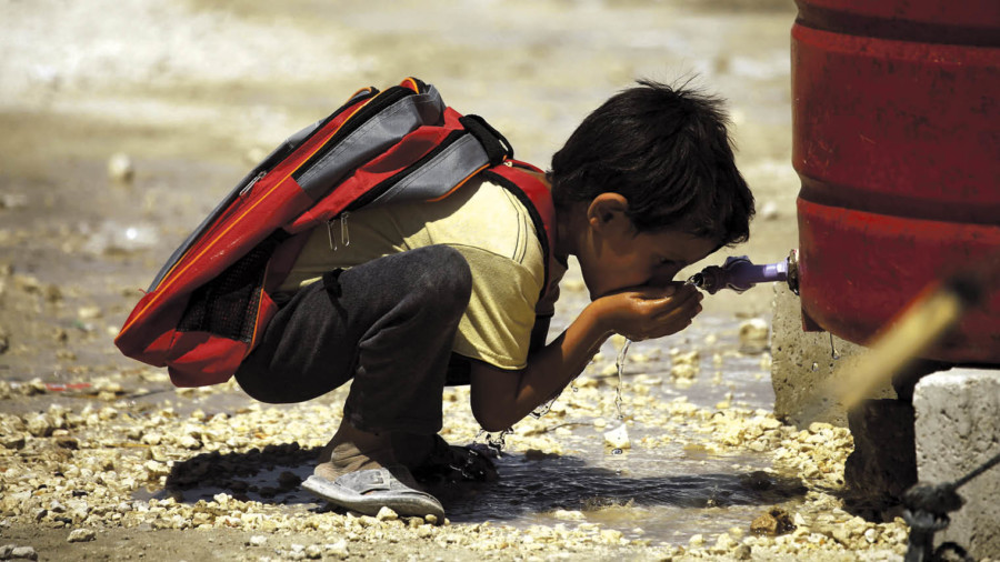 child drinks for water tap