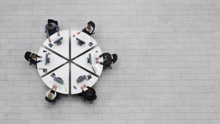 Staff sat at round table aerial view
