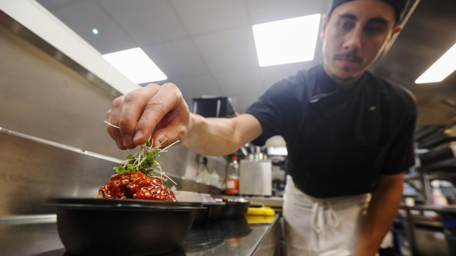 Chef putting garnish on Japanese food
