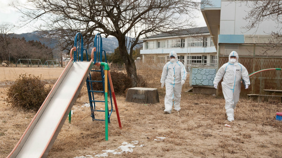 Workers in protective clothing after the Fukushima disaster