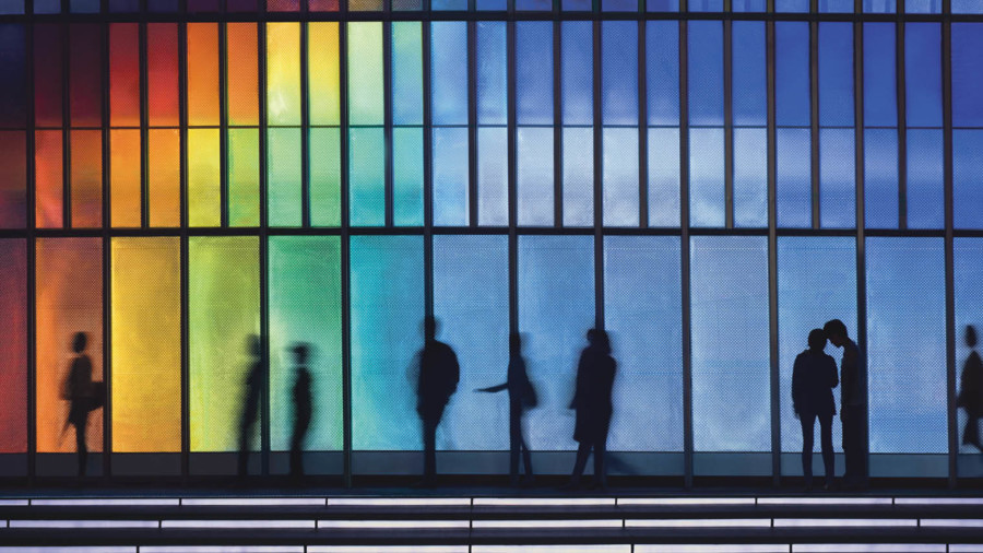 Rainbow building with people in front