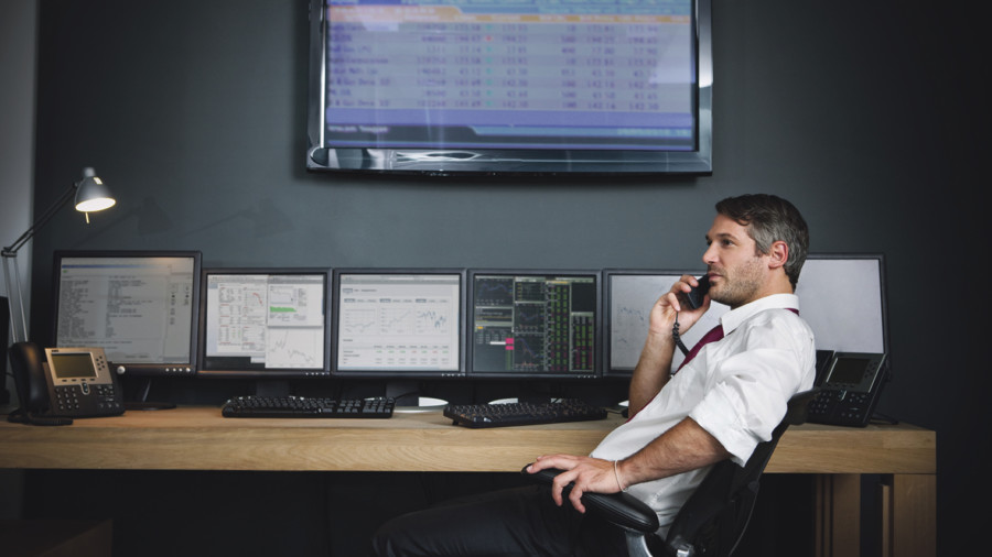 stock broker on the phone at desk