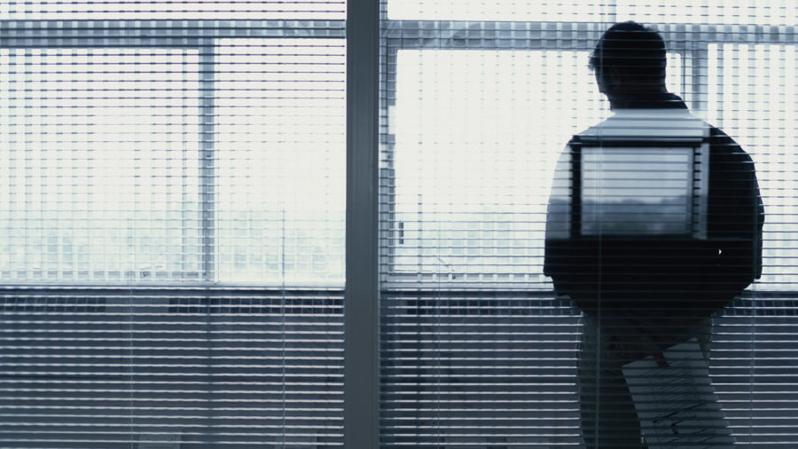Man by window with blinds