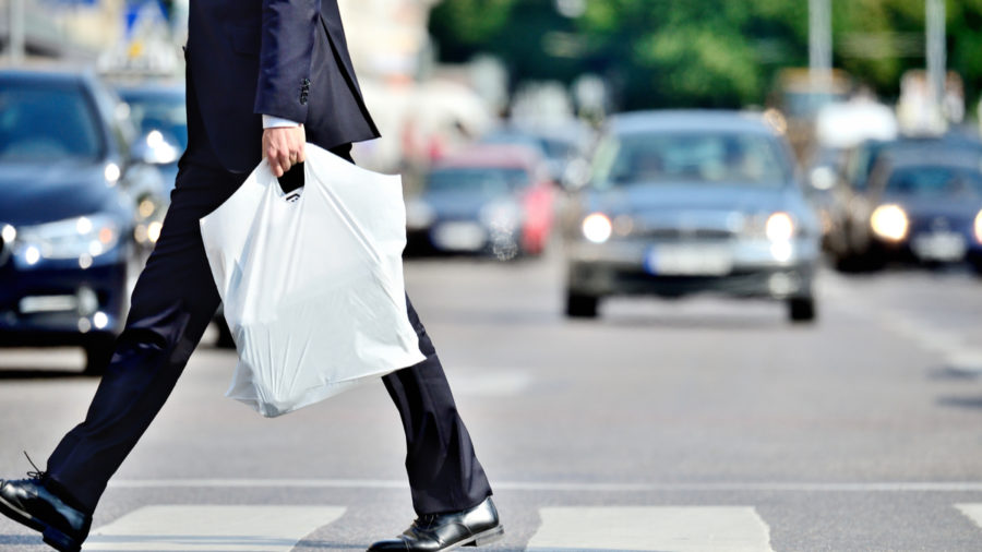 man with single-use plastic bag