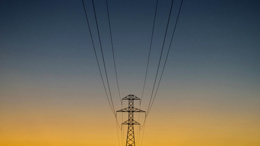 Electricity tower silhoutted against sky