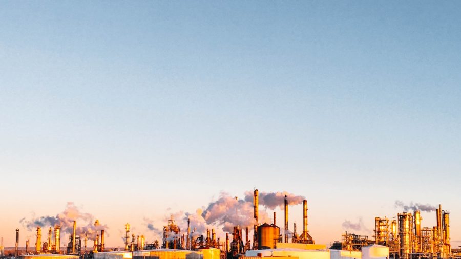 Factory smoke below blue sky