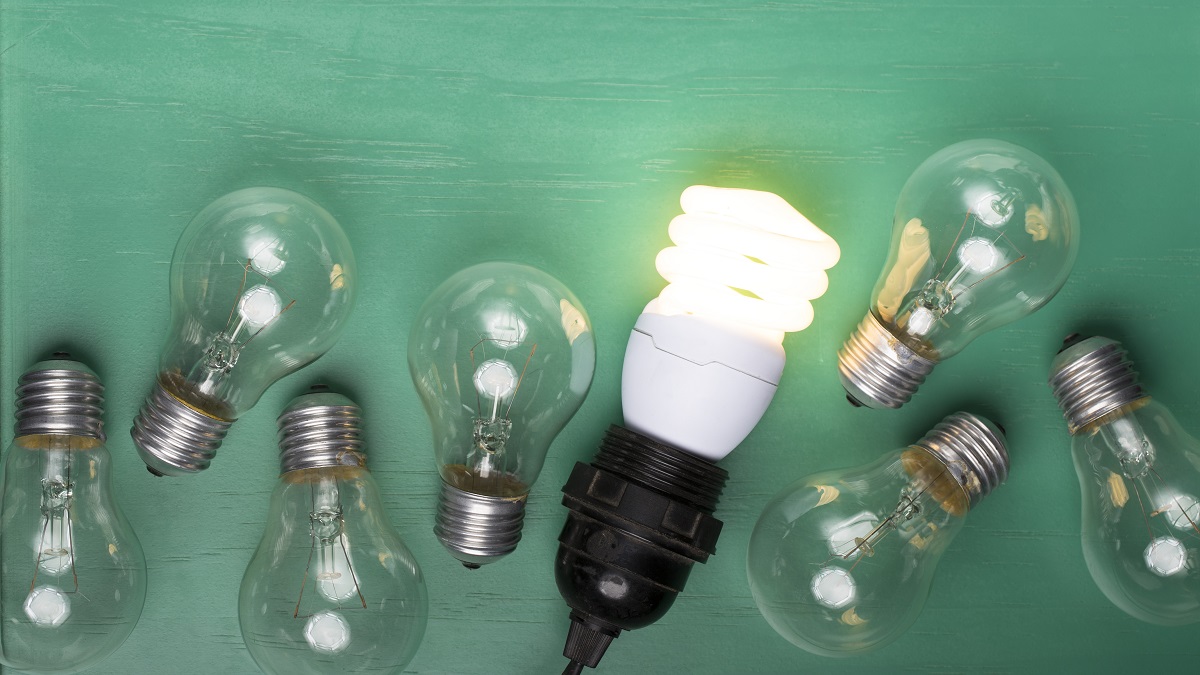 Filament lightbulbs next to one LED lightbulb