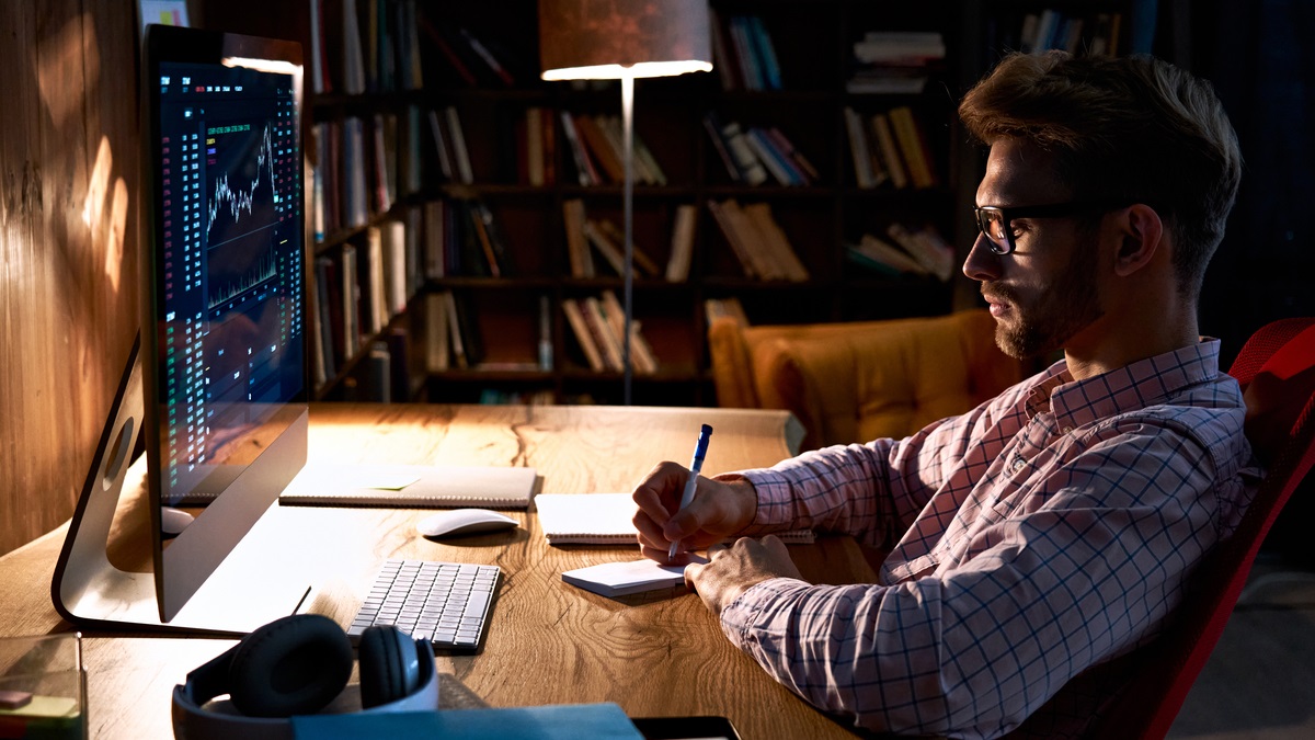 Man staring at trading stocks on screen