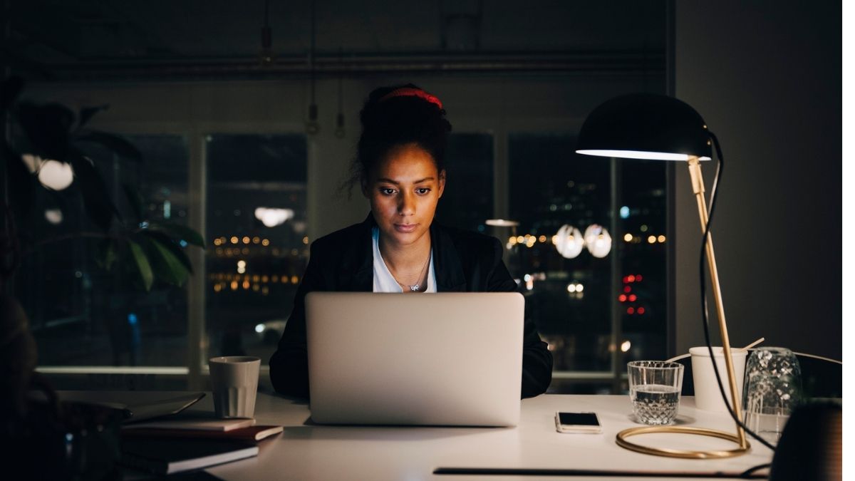 Woman working late at office desk