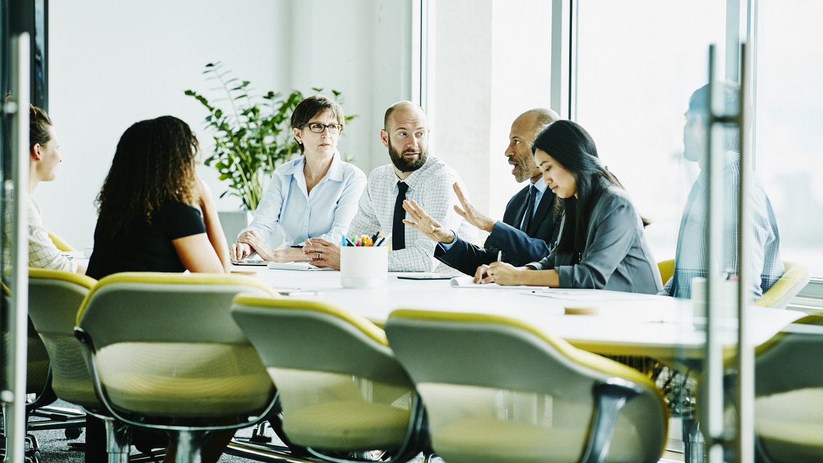 Mature businessman leading meeting in office conference room