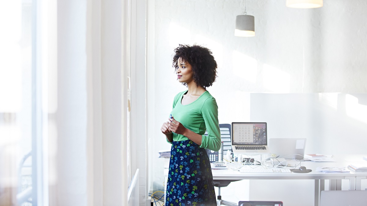 Woman in office looking out of a window
