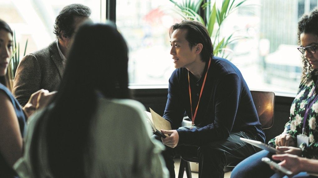 employees talking in group, sitting down
