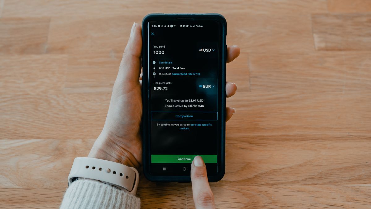 Woman uses an app to make a cross-border payment